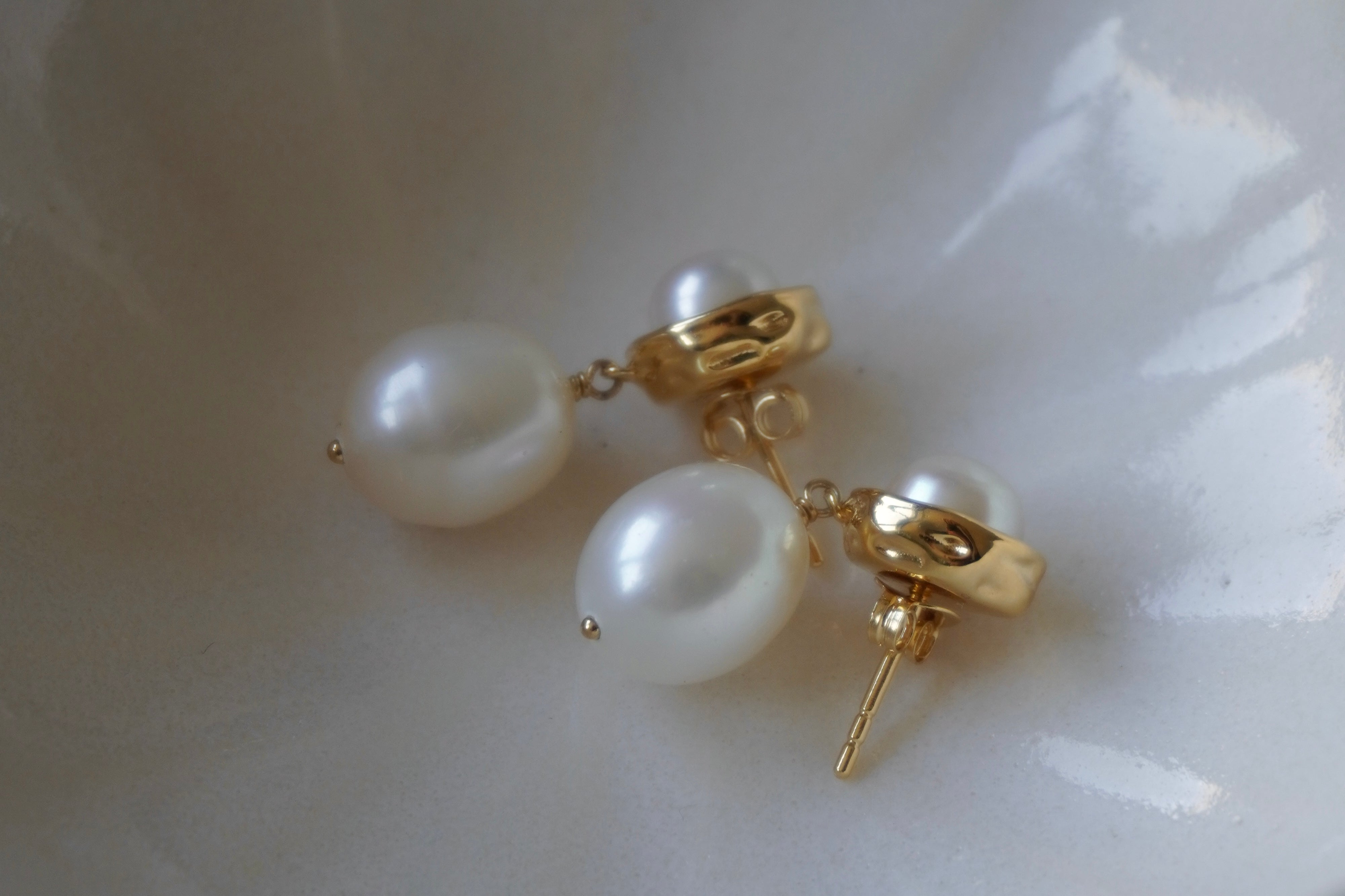 A pair of By Glaze recycled 18k gold hoop earrings with white double pearl drops perfect for bridal jewellery, bridesmaids or a chic statement pair 