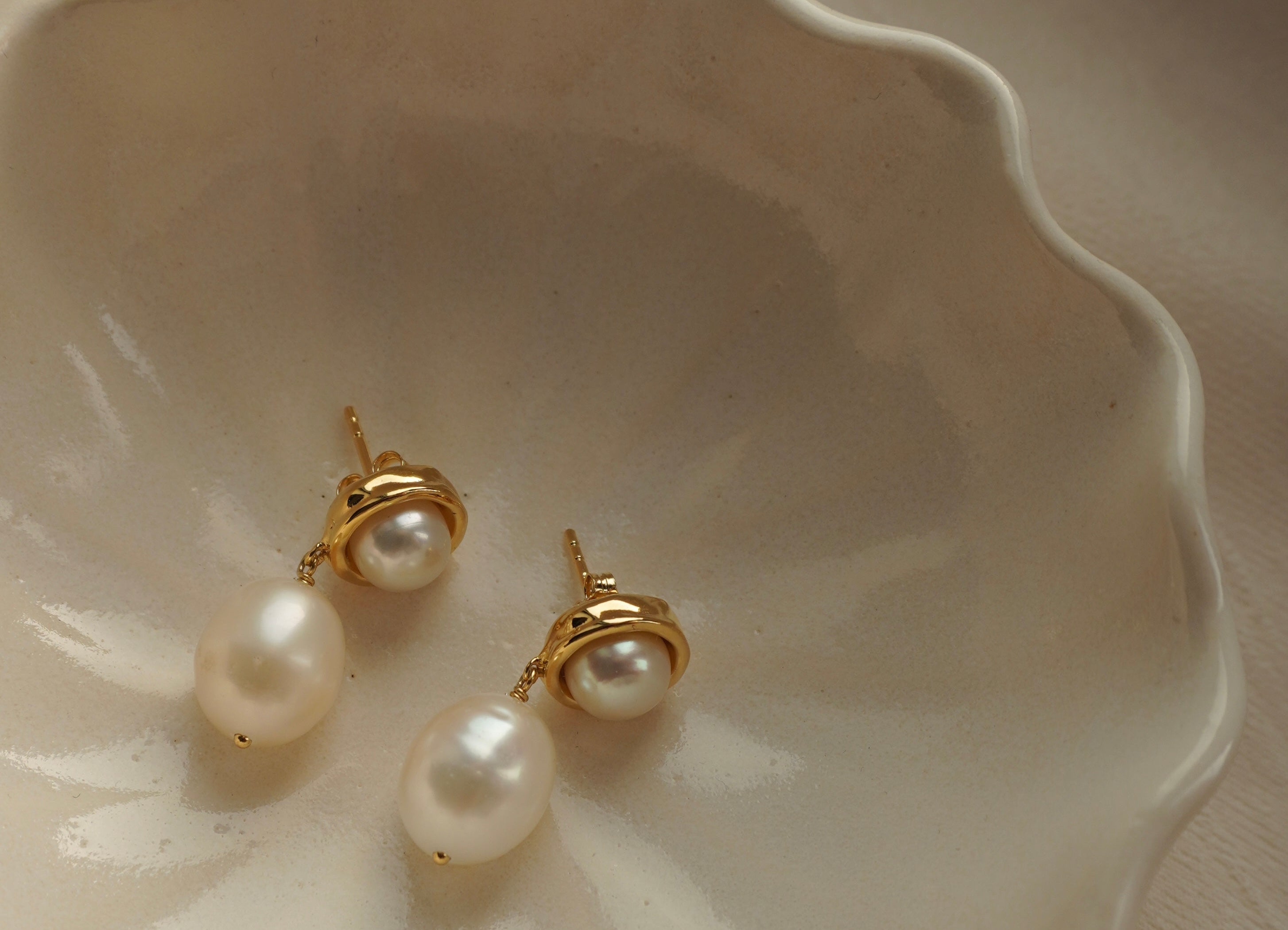 A pair of By Glaze recycled 18k gold hoop earrings with white double pearl drops perfect for bridal jewellery, bridesmaids or a chic statement pair 